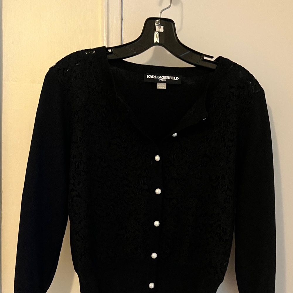 Black cropped lace front sweater with pearl buttons and three-quarter sleeves.